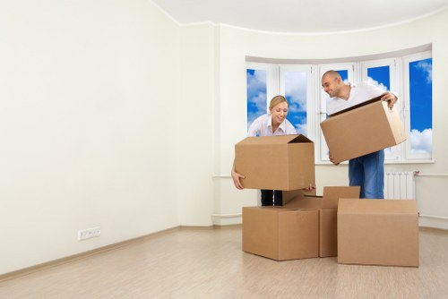 Professional movers handling furniture in an East London property