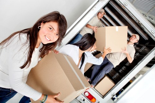 Relocation team unloading desks and boxes at a new office