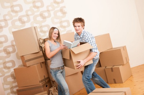 Professional movers handling furniture in a Mile End apartment