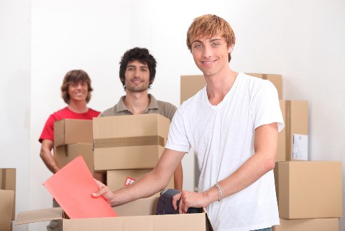 Movers navigating stairs and access in a Mile End flat